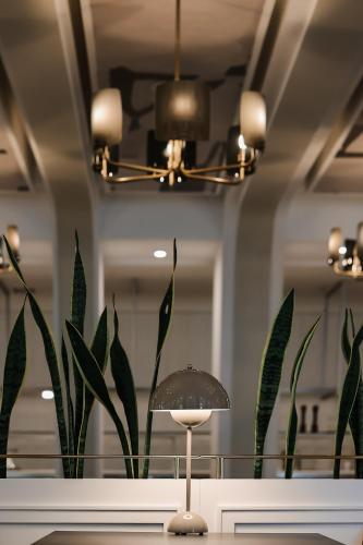 a table with a lamp in front of a mirror at Moselle Armenia Wellness & Medical SPA Jermuk in Jermuk