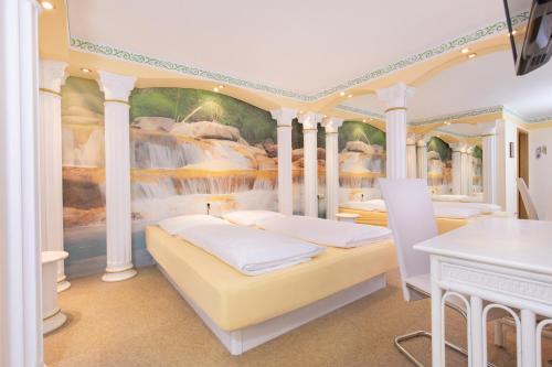 a bedroom with two beds and a waterfall mural at NEU 1001 Nacht Superzimmer mit Wasserbett in Altötting