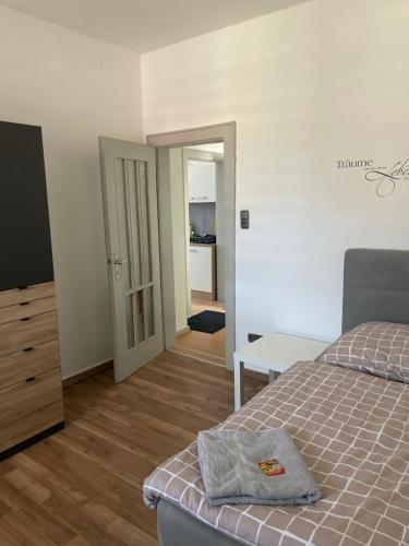 a bedroom with a bed and a door to a room at Monteurwohnungen WalMel kostenloses Parken und W-LAN in Bütthard