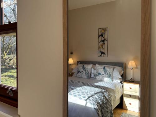a bedroom with a bed and a mirror at Cottage 474 - Kylemore in Kylemore