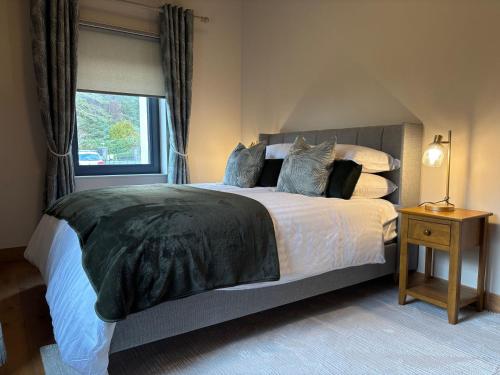 a bedroom with a large bed and a window at Cottage 475 - Kylemore in Kylemore