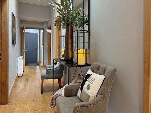 a living room with a chair and a table at Cottage 475 - Kylemore in Kylemore