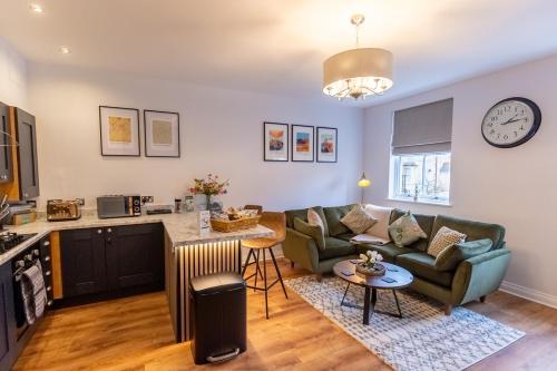 a living room with a couch and a table at The York House Luxury Apartment located in Llandudno in Llandudno
