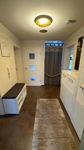 a room with a kitchen with a counter and a rug at Moderne Wohnung in Achern, Schwarzwald in Achern
