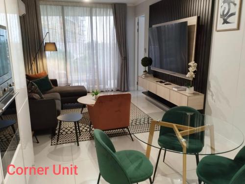 a living room with a couch and a tv at Stylish Modern 2BR in Waterfall Ellipse - Sleeps 4 - Fast WiFi - Secure Parking in Midrand