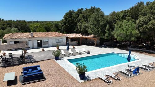 a villa with a swimming pool and a house at Casa Canetto, vous y êtes déjà! 14 personnes in Bonifacio