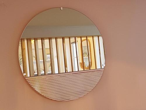 a mirror hanging on a wall with a fence at Gare Montparnasse,gorgeous1 bedroom,close to Eiffel tour,center , stuning place in Paris
