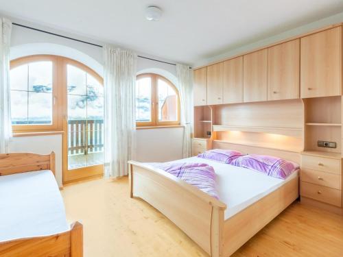 a bedroom with two beds and a large window at Welcoming apartment in Stummerberg with terrace in Stummerberg