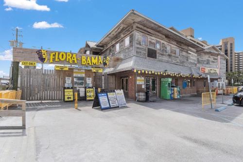 an old building with a flower bank on the street at Molokai Villas Riverside 7A in Perdido Key