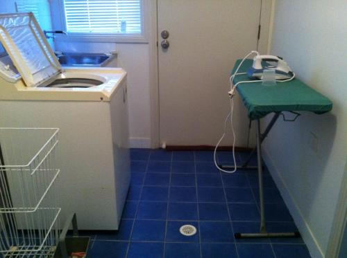 a small bathroom with a sink and a blue tile floor at The Residence @ Elbourne Wines in Lovedale