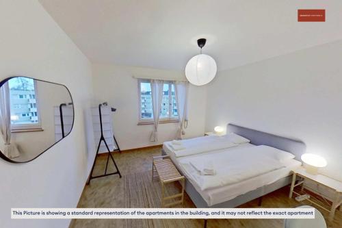 a bedroom with a bed and a mirror and a tripod at Basic 2BR with Natural Light in Zürich