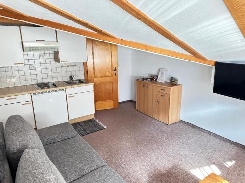 a living room with a couch and a kitchen at Ferienwohnung Vesna & Alex in Elmen