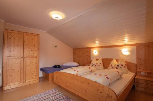 a bedroom with a large wooden bed in a room at Ferienwohnung Prent Wildschönau WILD023 by FeWo-Plan in Dorf