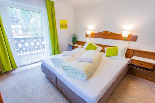 A bed or beds in a room at Soldanella 4 by Alpenidyll Apartments