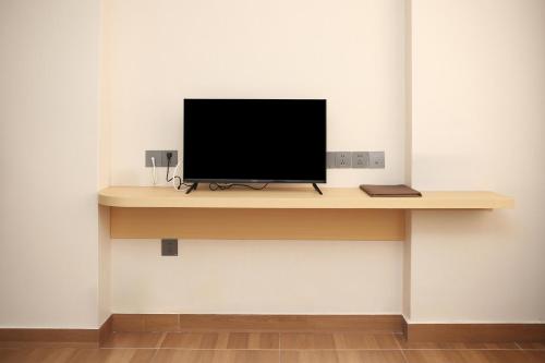 グリーン オアシス ホテルにあるテレビまたはエンターテインメントセンター