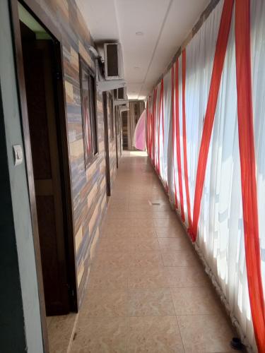 a hallway with red and white stripes on the wall at After Labour in Lomé