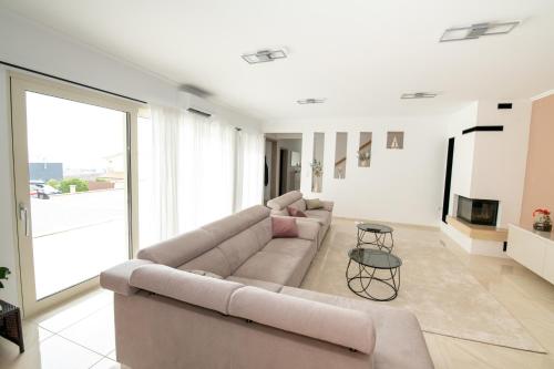 a living room with a couch and a tv at Villa Angela in Šmrika