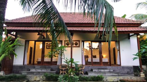 a villa with a view of a house at Pondok Kakiang in Pulukan