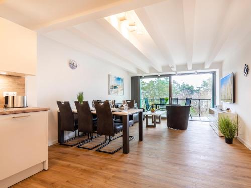 a kitchen and dining room with a table and chairs at FeWo Prora - Dünenheide 3.3 in Binz