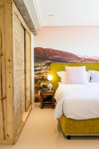 a bedroom with a large bed and a window at Cape Heritage Hotel in Cape Town