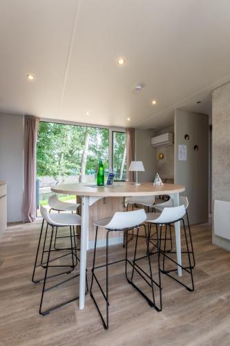a kitchen with a large white table and chairs at Düne 46 in Scharbeutz
