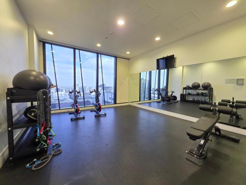 a gym with cardio equipment and a view of the city at Melbourne CBD Southern Cross Collins St Skyline View Balcony in Melbourne
