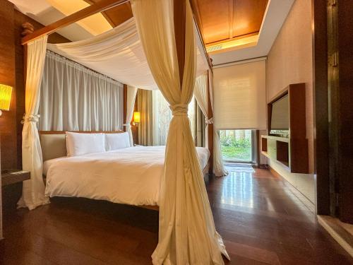 a bedroom with a bed with a canopy at Norway Forest Tamsui Motel in Tamsui