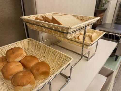 two baskets filled with bread on a table at Norway Forest Tamsui Motel in Tamsui