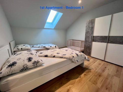 a bedroom with two beds and a crib in it at Cozy Apartment near Vienna Airport in Schwechat