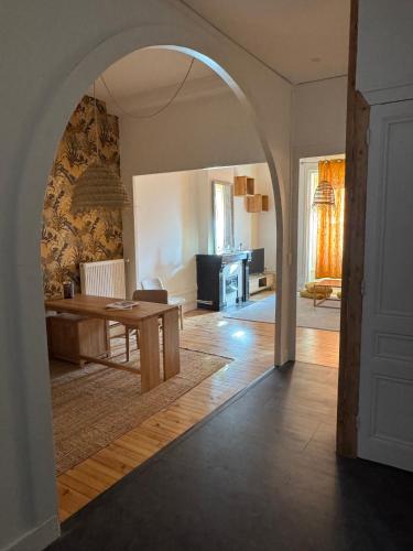 une voûte dans un salon avec une table dans l'établissement Le Nid Papin - Haussmanien de standing, à Saint-Étienne