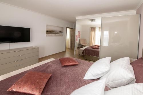 a bedroom with a bed with two pillows on it at Villa Angela in Šmrika