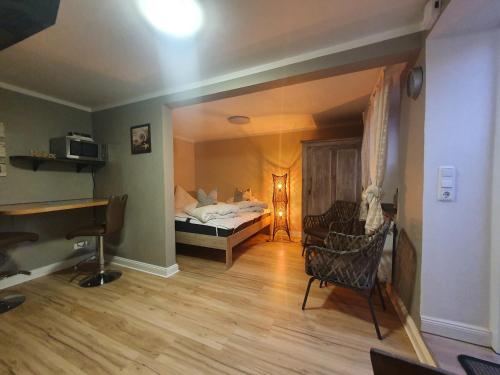 a room with a bedroom with a bed and a piano at Ferienwohnung "Unner Deck" in Sahrensdorf