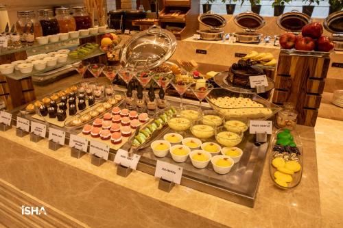 a buffet with many different types of food on display at The Gaurs Sarovar Premiere in Ghaziabad