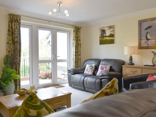 a living room with a couch and a window at Elizabeth House in Bampton