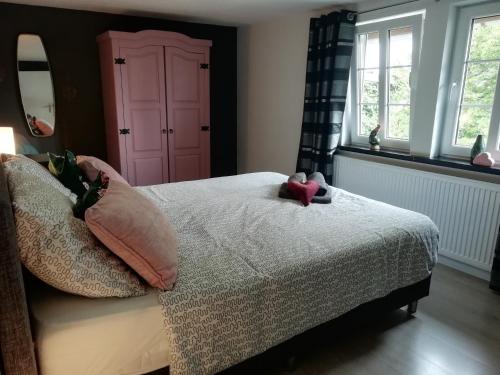 a bedroom with a bed with two stuffed animals on it at Haus Blick am Edersee 13 p in Waldeck