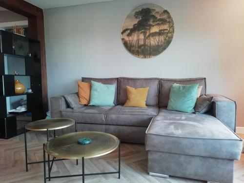 a living room with a couch and two tables at Haus Blick am Edersee 13 p in Waldeck
