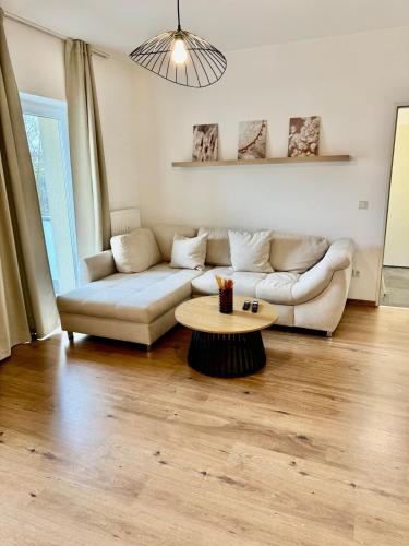 a living room with a couch and a coffee table at FeWo-Palmtrees 3 - Große und moderne 2 Zimmerwohnung mit Süd-West Balkon in Gladbeck-Mitte nähe Movie Park und Arena AufSchalke in Gladbeck
