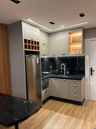 Kuchyň nebo kuchyňský kout v ubytování Studio-Apartamento de Alto Padrao