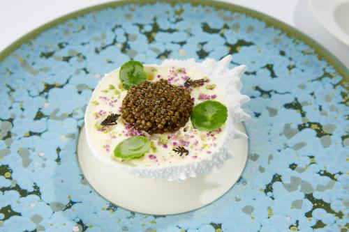 a cake on a blue and white plate at Domaine les Crayères in Reims