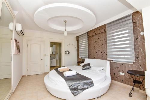 a large white bedroom with a large white bed at Villa Maya The Royal Links Sarigerme in Sarigerme