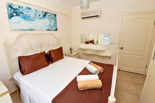 a bedroom with a large white bed in a room at Villa Maya The Royal Links Sarigerme in Sarigerme