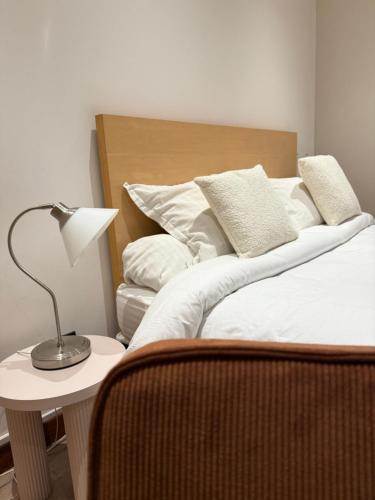 a bedroom with a bed and a lamp on a table at Savoy Hotel in Le Bourget-du-Lac