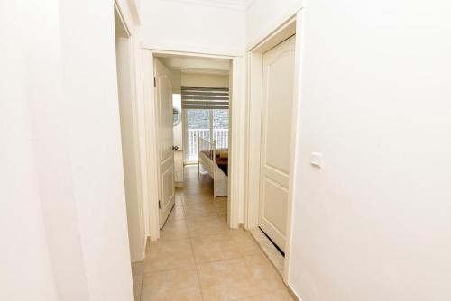 a hallway with white walls and a tile floor at Villa Maya The Royal Links Sarigerme in Sarigerme