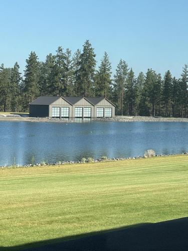 a large building sitting on the side of a lake at Palla Wake 6 Night Minimum in Bend