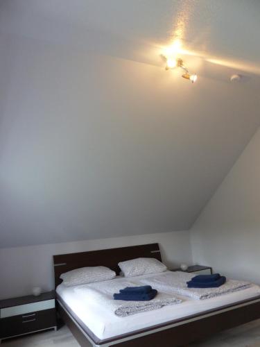 a bedroom with a bed with two blue towels on it at Ferienhaus Sonnenblick in Walsrode