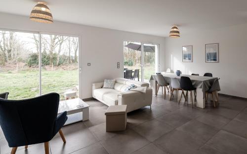 un salon avec un canapé et une table dans l'établissement La Maison aux Chevreuils, à Parentis-en-Born