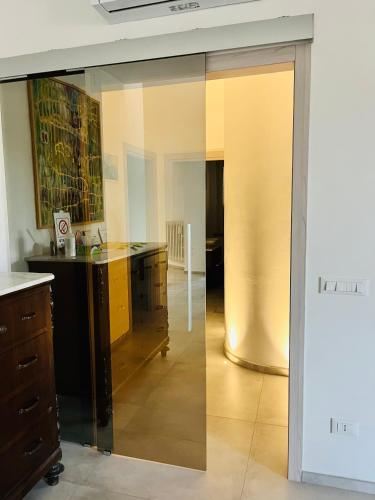 a sliding glass door in a room with a desk at Affittacamere Roberta in Osimo