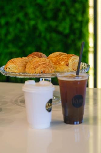 a plate of pastries on a table with a cup of coffee at Caddem Inn Hotel in Mağusa