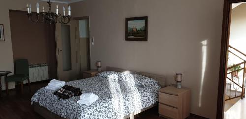 a bedroom with a bed and a picture on the wall at Casa Jalla' - Stanza Marisa in Luserna San Giovanni