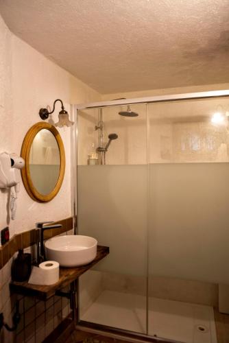 a bathroom with a glass shower and a sink at Borgo Castello Sidra GG in Artena